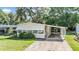 Inviting single-story home with a covered carport and mature landscaping at 3542 Castle Dr, Zephyrhills, FL 33540
