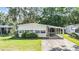 Charming single-story home featuring a covered carport and well-maintained front lawn at 3542 Castle Dr, Zephyrhills, FL 33540