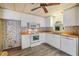 Bright kitchen with white cabinets, wood countertops, and modern appliances at 3542 Castle Dr, Zephyrhills, FL 33540