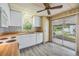 Open kitchen with wood countertops, white appliances, and access to a screened patio at 3542 Castle Dr, Zephyrhills, FL 33540