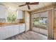Bright kitchen featuring white cabinetry, wood countertops, and a sliding door to the screened porch at 3542 Castle Dr, Zephyrhills, FL 33540