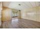 Spacious living room with wood-style flooring and sliding glass doors to the outdoors at 3542 Castle Dr, Zephyrhills, FL 33540