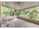 Relaxing screened porch with a ceiling fan and views of the lush, green backyard at 3542 Castle Dr, Zephyrhills, FL 33540