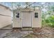 Exterior of detached shed with neutral siding and shingled roof at 3542 Castle Dr, Zephyrhills, FL 33540