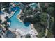 Aerial view of Loch Ness Community featuring multiple pools, water features, and lush greenery at 36750 Us 19 N # 08204, Palm Harbor, FL 34684
