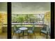 Balcony with chairs and table overlooking view of the parking lot and lush landscaping at 36750 Us 19 N # 08204, Palm Harbor, FL 34684