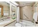 Bright bathroom featuring a shower-tub with grab bar, granite countertops, and a well-lit mirror at 36750 Us 19 N # 08204, Palm Harbor, FL 34684