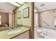 Cozy bathroom featuring a shower-tub combo, granite countertops, and a well-lit vanity area at 36750 Us 19 N # 08204, Palm Harbor, FL 34684