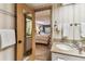 Bedroom featuring two beds leading into a bathroom with granite countertops, and a well-lit mirror at 36750 Us 19 N # 08204, Palm Harbor, FL 34684