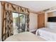 Bedroom featuring two beds and leaf designed decorations with view of balcony at 36750 Us 19 N # 08204, Palm Harbor, FL 34684