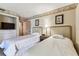 Bedroom featuring two beds and leaf designed decorations with a tv on the left at 36750 Us 19 N # 08204, Palm Harbor, FL 34684