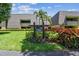 Lahinch Lodges features lush landscaping around building number five with palm trees and colorful flowers at 36750 Us 19 N # 08204, Palm Harbor, FL 34684