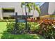 Lahinch Lodges features lush landscaping around building number five with palm trees and colorful flowers at 36750 Us 19 N # 08204, Palm Harbor, FL 34684
