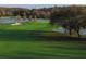 Scenic golf course with a lakeside view, showcasing the green fairway, a sand trap, and reflections on the water at 36750 Us 19 N # 08204, Palm Harbor, FL 34684