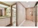 Hallway with bathroom visible through doorway and entrance door to the condo with modern lock at 36750 Us 19 N # 08204, Palm Harbor, FL 34684