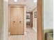 Hallway with wood-look flooring and light wood closet doors leading to a bedroom with two beds at 36750 Us 19 N # 08204, Palm Harbor, FL 34684