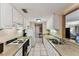 Efficient kitchen with white cabinets and granite countertops, with a view to the living room at 36750 Us 19 N # 08204, Palm Harbor, FL 34684