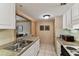 Efficient kitchen featuring white cabinets, granite countertops, and an stainless steel sink at 36750 Us 19 N # 08204, Palm Harbor, FL 34684