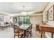 Open living and dining space featuring wood flooring, and sliding glass doors to patio at 36750 Us 19 N # 08204, Palm Harbor, FL 34684