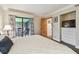 Well-lit bedroom with balcony access, TV, dresser, and view of outdoor seating at 36750 Us 19 N # 15309, Palm Harbor, FL 34684