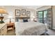 Bright bedroom with slider doors leading to outdoor patio, decorated with framed prints at 36750 Us 19 N # 15309, Palm Harbor, FL 34684