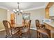 A dining area offers seating for six beneath an elegant chandelier, with kitchen view at 36750 Us 19 N # 15309, Palm Harbor, FL 34684