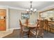 Condo dining area shows chandelier, table with chairs and access to the breakfast bar at 36750 Us 19 N # 15309, Palm Harbor, FL 34684