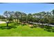 Scenic view of the lush green golf course, mature trees, and parking lot from the property at 36750 Us 19 N # 15309, Palm Harbor, FL 34684