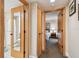 Hallway leads to a bathroom with a mirror door and a bedroom with a cozy bed at 36750 Us 19 N # 15309, Palm Harbor, FL 34684