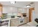 Traditional kitchen with white cabinets, tiled floor, and white appliances at 36750 Us 19 N # 15309, Palm Harbor, FL 34684