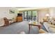 Living room area with sofa and chairs, sliding glass doors, neutral carpet at 36750 Us 19 N # 15309, Palm Harbor, FL 34684