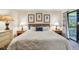 Comfortable main bedroom with a queen-sized bed, side tables, and large window with outdoor view at 36750 Us 19 N # 15309, Palm Harbor, FL 34684