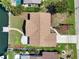 Aerial top-down view of house featuring nice roof, landscaping, and waterfront access at 3932 Shore Acres Ne Blvd, St Petersburg, FL 33703