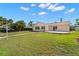 Expansive backyard with lush green lawn and mature trees at 3932 Shore Acres Ne Blvd, St Petersburg, FL 33703