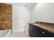Modern bathroom features a tile accent wall, sleek vanity, and updated fixtures at 3932 Shore Acres Ne Blvd, St Petersburg, FL 33703