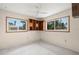 Bedroom with neutral walls, built-in shelving, and two windows at 3932 Shore Acres Ne Blvd, St Petersburg, FL 33703