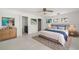 Comfortable bedroom boasts a plush bed, neutral decor, and access to ensuite bathroom and closet at 3932 Shore Acres Ne Blvd, St Petersburg, FL 33703