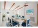 Dining room featuring ceiling beams, round windows, modern ceiling fan, and seating for six at 3932 Shore Acres Ne Blvd, St Petersburg, FL 33703