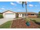 Charming single-story home with tan exterior, brick accents, and a well-maintained landscaped front yard at 3932 Shore Acres Ne Blvd, St Petersburg, FL 33703