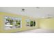 Bright living room with terrazzo floors, a ceiling fan and large windows offering water views at 3932 Shore Acres Ne Blvd, St Petersburg, FL 33703