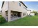 Backyard featuring outdoor patio, well-maintained lawn, and house exterior at 3952 Aldea Way, Wesley Chapel, FL 33543