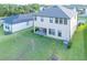 Backyard with open patio, volleyball net, and well-maintained lawn at 3952 Aldea Way, Wesley Chapel, FL 33543