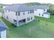 Spacious backyard featuring a patio with seating and a volleyball net at 3952 Aldea Way, Wesley Chapel, FL 33543