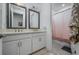 Double sink bathroom vanity featuring framed mirrors, modern fixtures and access to a shower room at 3952 Aldea Way, Wesley Chapel, FL 33543