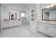 Bright bathroom featuring double vanities, stylish mirrors, and a modern glass shower at 3952 Aldea Way, Wesley Chapel, FL 33543