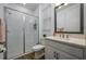 Well-lit bathroom with a glass shower, vanity, and wood-look flooring at 3952 Aldea Way, Wesley Chapel, FL 33543
