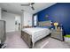 Bedroom featuring an accent wall and an open view to the en-suite bath at 3952 Aldea Way, Wesley Chapel, FL 33543