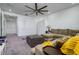 Cozy bonus room is well-lit with a large sectional sofa and murphy bed at 3952 Aldea Way, Wesley Chapel, FL 33543