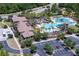 Aerial view of a large community pool, clubhouse, and ample parking at 3952 Aldea Way, Wesley Chapel, FL 33543