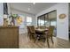 Cozy dining room with elegant table setting and sliding glass doors to the patio at 3952 Aldea Way, Wesley Chapel, FL 33543